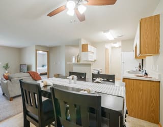 the view of the living room and dining room with table and chairs