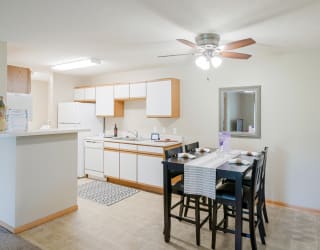 a kitchen and dining room with a table and chairs