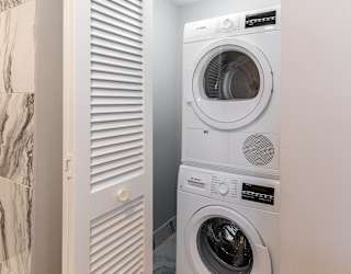 a small laundry room with a washing machine and a dryer