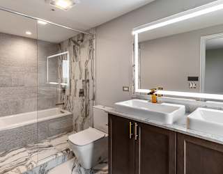 a bathroom with a shower toilet and sink and a mirror