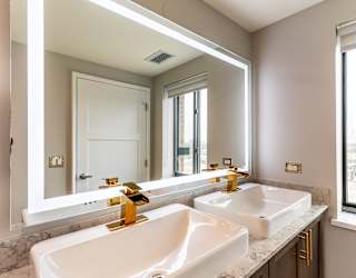 a bathroom with two sinks and a large mirror
