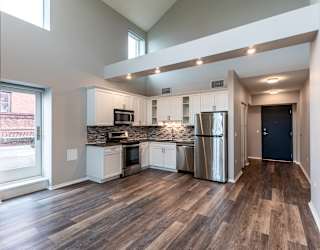an open kitchen with stainless steel appliances and a large window