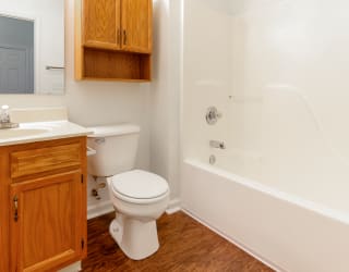 a bathroom with a toilet and a sink and a bath tub