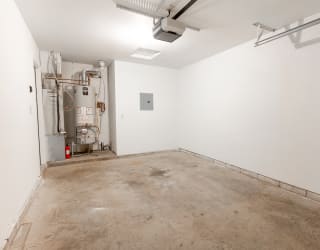 an empty room with a cement floor and white walls