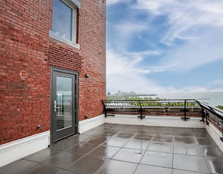 the private balcony has a view of the lake and the city