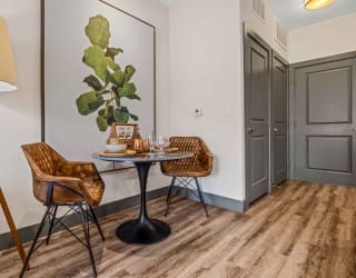 a dining area with a table and two chairs
