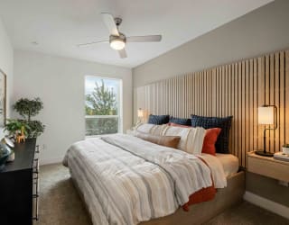 a bedroom with a bed and a ceiling fan
