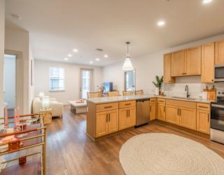 A modern kitchen with wooden cabinets and stainless steel appliances.