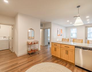 A kitchen with wooden floors and white walls.
