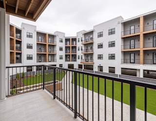 A balcony with black railings and a white door.