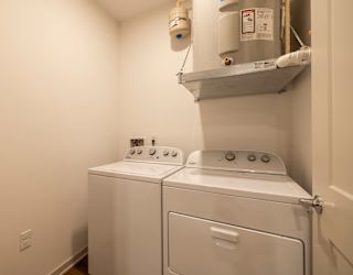 A small laundry room with a washer and dryer.