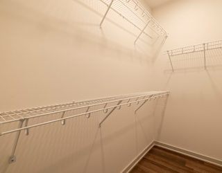A white wall with a metal rack on it.