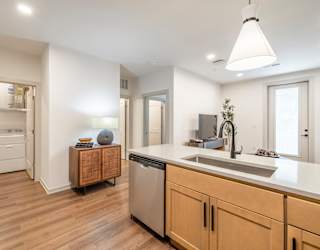 A modern kitchen with wooden floors and a large island.