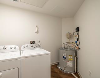 A small laundry room with a washer and dryer.