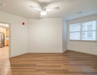 A room with a wooden floor and a ceiling fan.