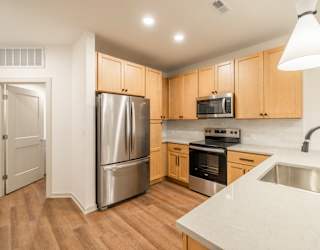 A kitchen with wooden cabinets and stainless steel appliances.