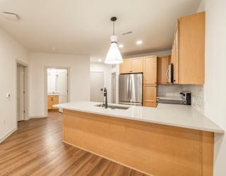 A kitchen with wooden cabinets and a white countertop.