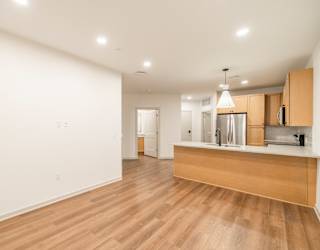 A kitchen with a wooden counter and white walls.