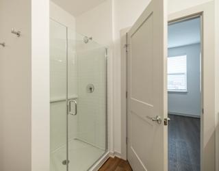 A white door with a glass panel is open.