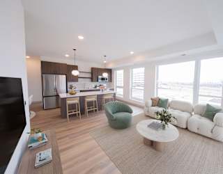 Living, dining, and kitchen areas in the C4 two bedroom two bathroom floor plan at The Mera in St. Louis Park, Minnesota