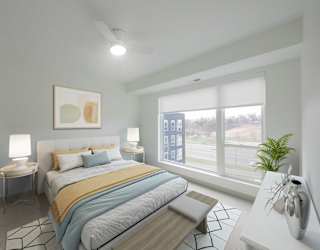 Primary bedroom in the CC3 two bedroom plus den, two bathroom floor plan at The Mera in St. Louis Park, Minnesota
