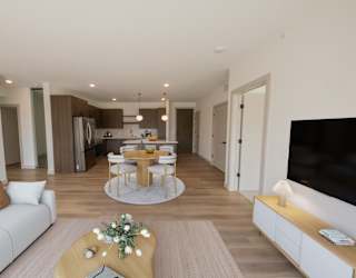 Living room, kitchen, and dining area in the CC3 two bedroom plus den, two bathroom floor plan at The Mera in St. Louis Park, Minnesota