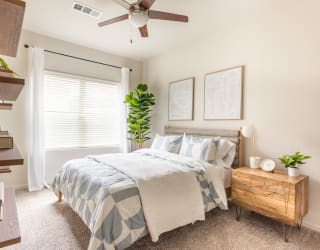 a bedroom with a large bed and a ceiling fan