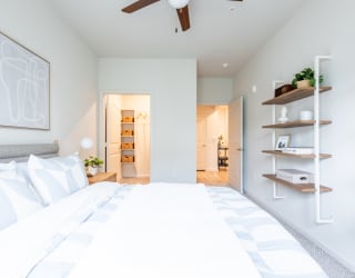 a bedroom with a bed and a ceiling fan