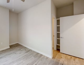 an empty room with wood floors and a window