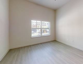 A room with a window and a door.
