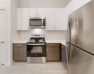 A modern kitchen with a stainless steel refrigerator.
