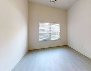 A room with a window and a door.