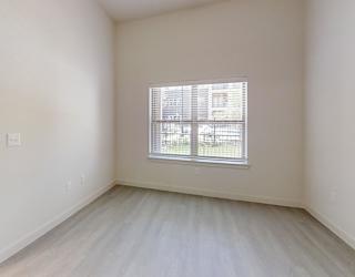 A room with a window and a door.