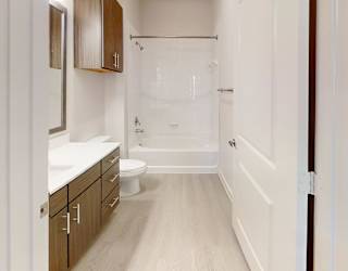 A bathroom with a walk in shower and a toilet.