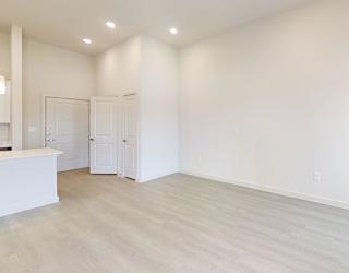 A white room with a bar and two doors.