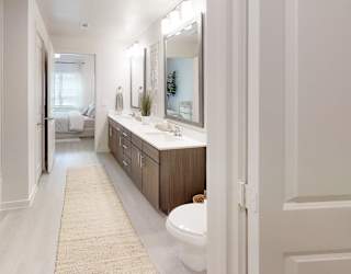 A bathroom with a white tub, sink, and toilet.