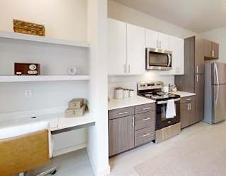 A modern kitchen with a white bathtub.