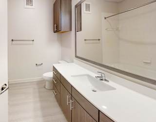 A white bathroom with a toilet and sink.