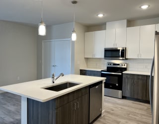 a kitchen with white cabinets and a white counter top