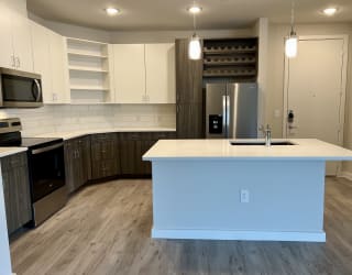 a kitchen with a center island and a stove top oven