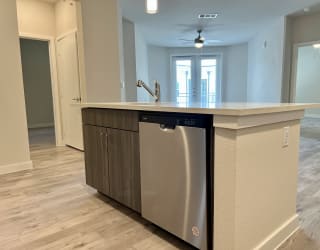 a kitchen with an island and a dishwasher