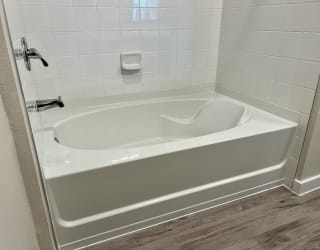 a large white bathtub in a bathroom