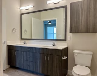 a bathroom with a toilet sink and mirror