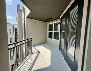 a balcony with a large window and a door