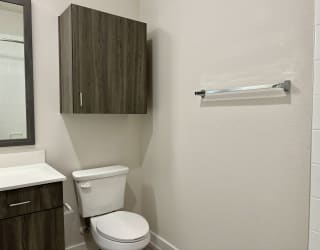 a bathroom with a toilet sink and mirror