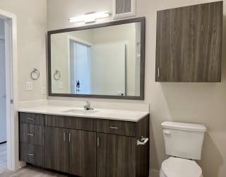 a bathroom with a toilet sink and mirror