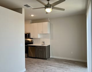 a bedroom with a ceiling fan in a room
