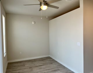 an empty room with a ceiling fan