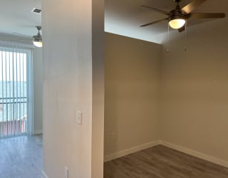 a bedroom with a ceiling fan and a window