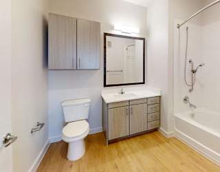 A white toilet sits next to a sink in a small bathroom.